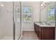 Elegant bathroom with granite countertops, double sinks, and a glass-enclosed shower at 11541 Fountainhead Dr, Tampa, FL 33626