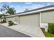 View of the home's garage, driveway, mailbox, and greenery at 11541 Fountainhead Dr, Tampa, FL 33626