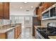 Bright kitchen featuring stainless appliances, granite countertops, tile flooring, and sliding glass doors at 11541 Fountainhead Dr, Tampa, FL 33626