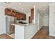 Bright kitchen features stainless steel appliances, granite countertops, breakfast bar, and wood floors at 11541 Fountainhead Dr, Tampa, FL 33626