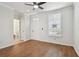 Inviting living area with wood floors, ceiling fan, natural light, and adjacent powder room at 11541 Fountainhead Dr, Tampa, FL 33626