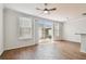 Bright living room featuring wood floors, ceiling fan, and sliding glass doors to a private patio at 11541 Fountainhead Dr, Tampa, FL 33626