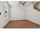 Clean, open room with wood floors, large window, ceiling fan, and stairs to the second story at 11541 Fountainhead Dr, Tampa, FL 33626