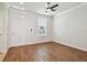 Open-concept room featuring a ceiling fan, wood floors, a door, and natural light at 11541 Fountainhead Dr, Tampa, FL 33626