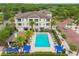 Inviting community pool surrounded by palm trees, lounge chairs, and cabanas for a relaxing atmosphere at 11541 Fountainhead Dr, Tampa, FL 33626