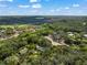 Aerial view of rural homes in wooded area highlighting the community setting at 13015 Elm St, Odessa, FL 33556
