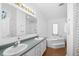 Bathroom featuring double vanity, separate soaking tub, and tile flooring at 13015 Elm St, Odessa, FL 33556
