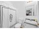 Cozy bathroom with monogrammed shower curtain, white fixtures, and ample lighting at 13015 Elm St, Odessa, FL 33556