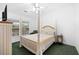 Comfortable bedroom featuring a beautiful four-poster bed and lots of natural light at 13015 Elm St, Odessa, FL 33556