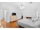 Primary bedroom featuring hardwood floors, dresser, and ensuite bathroom at 13015 Elm St, Odessa, FL 33556