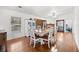 Bright dining space with hardwood floors, a dining table, and a cabinet for storage at 13015 Elm St, Odessa, FL 33556