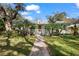 Charming single-story home with a brick walkway, palm trees, and a welcoming front porch at 13015 Elm St, Odessa, FL 33556