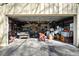 Spacious garage filled with an assortment of tools and machinery, offering ample storage at 13015 Elm St, Odessa, FL 33556