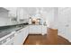 Functional kitchen featuring white cabinets, a stainless steel sink, and modern appliances at 13015 Elm St, Odessa, FL 33556