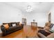 Spacious living room with hardwood floors, a ceiling fan, and access to the dining area at 13015 Elm St, Odessa, FL 33556