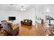 Cozy living area with hardwood floors, a ceiling fan, and a view into the kitchen at 13015 Elm St, Odessa, FL 33556