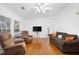 Bright living room featuring wood floors, white walls, and comfortable seating arrangements at 13015 Elm St, Odessa, FL 33556