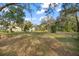 Expansive yard with outbuildings, mature trees, and lush greenery offering endless possibilities at 13015 Elm St, Odessa, FL 33556