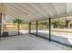 The covered back porch has a brick paver floor and fenced in yard at 15124 Omaha St, Hudson, FL 34667