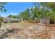 Wide backyard featuring a shed, screened porch, and a privacy fence at 15124 Omaha St, Hudson, FL 34667