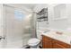 This bright bathroom has a glass-enclosed tiled shower and a dark vanity at 15124 Omaha St, Hudson, FL 34667