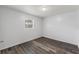 This bedroom features wood-look floors and a window offering natural light at 15124 Omaha St, Hudson, FL 34667