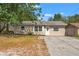 Charming single-story home featuring a well-manicured lawn and a private driveway at 15124 Omaha St, Hudson, FL 34667