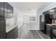 Efficient kitchen layout featuring granite countertops, black appliances and open access to living area at 15124 Omaha St, Hudson, FL 34667