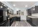 Contemporary kitchen featuring sleek appliances, granite countertops, and convenient access to backyard at 15124 Omaha St, Hudson, FL 34667
