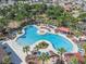 Aerial view of community pool featuring ample lounge seating and lush landscaping at 15306 Broad Brush Dr, Sun City Center, FL 33573