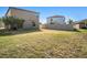 Spacious backyard area with green space, and secure fence at 15306 Broad Brush Dr, Sun City Center, FL 33573