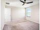 This carpeted bedroom features a modern ceiling fan and plenty of natural light at 15306 Broad Brush Dr, Sun City Center, FL 33573
