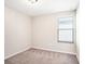 This bedroom has neutral paint, carpeting and a window for natural light at 15306 Broad Brush Dr, Sun City Center, FL 33573