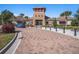 Community clubhouse featuring a brick tower, ample parking and bike racks at 15306 Broad Brush Dr, Sun City Center, FL 33573