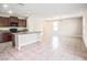 Open concept kitchen with a large island, tile flooring, and stainless steel appliances at 15306 Broad Brush Dr, Sun City Center, FL 33573