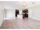 Open concept living room and kitchen with tile floors and decorative lighting at 15306 Broad Brush Dr, Sun City Center, FL 33573
