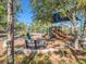 Community playground with swings, slides, and a shaded area for to enjoy at 15306 Broad Brush Dr, Sun City Center, FL 33573