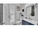 This bathroom features a modern vanity and a stylish white door with shutter details at 15507 Avocetview Ct, Lithia, FL 33547