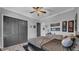 The bedroom has a ceiling fan, natural light, and lots of wall art at 15507 Avocetview Ct, Lithia, FL 33547