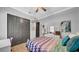 Bright bedroom with closet and patterned bedding at 15507 Avocetview Ct, Lithia, FL 33547