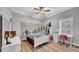 Bright bedroom featuring a ceiling fan and a work space at 15507 Avocetview Ct, Lithia, FL 33547