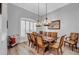 Dining room with hardwood floors, large windows and chandelier lighting at 15507 Avocetview Ct, Lithia, FL 33547