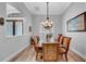 Dining room with hardwood floors, chandelier and view into the foyer at 15507 Avocetview Ct, Lithia, FL 33547