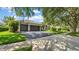 View of the driveway with a basketball hoop and well-maintained landscaping at 15507 Avocetview Ct, Lithia, FL 33547