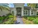 A well-manicured walkway leads to the covered front entrance of the home at 15507 Avocetview Ct, Lithia, FL 33547