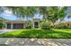 Beautiful home featuring lush landscaping, a gray color scheme and a large driveway at 15507 Avocetview Ct, Lithia, FL 33547
