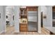 Kitchen area with a wine rack, stainless steel refrigerator, and wooden cabinets at 15507 Avocetview Ct, Lithia, FL 33547