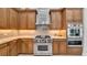 Gourmet kitchen features custom cabinets, stone countertops, and stainless steel Wolf appliances at 15507 Avocetview Ct, Lithia, FL 33547
