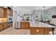 Spacious kitchen boasts a large island, stainless steel appliances and light wood flooring at 15507 Avocetview Ct, Lithia, FL 33547