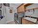 The laundry room features modern appliances and plenty of storage space at 15507 Avocetview Ct, Lithia, FL 33547